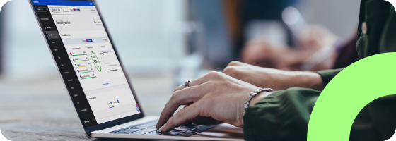 Person typing on a laptop looking at the Siteimprove dashboard.