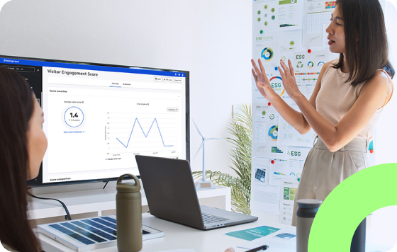 Two people collaborating and one person giving a presentation showing a website visitor engagement score in the Siteimprove platform.