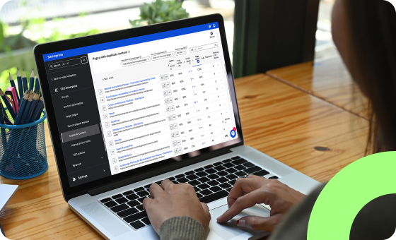 Person typing and looking at the Siteimprove platform under the SEO enterprise section at their pages with duplicate content.