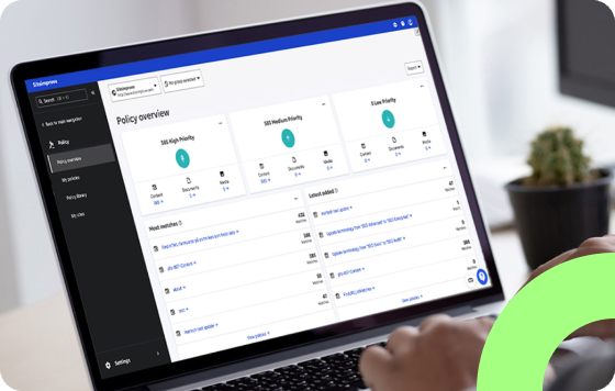 Hands typing on a laptop looking at policy overview in the Siteimprove platform.